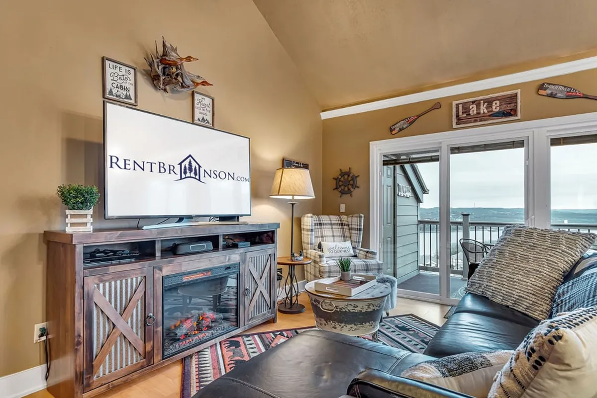 This image showcases a comfortable seating area with a television, decorative wall accents, and a relaxed, inviting mood. The setup is suited for enjoying movies, game nights, or simply hanging out together, which aligns with the described uses of the loft.
